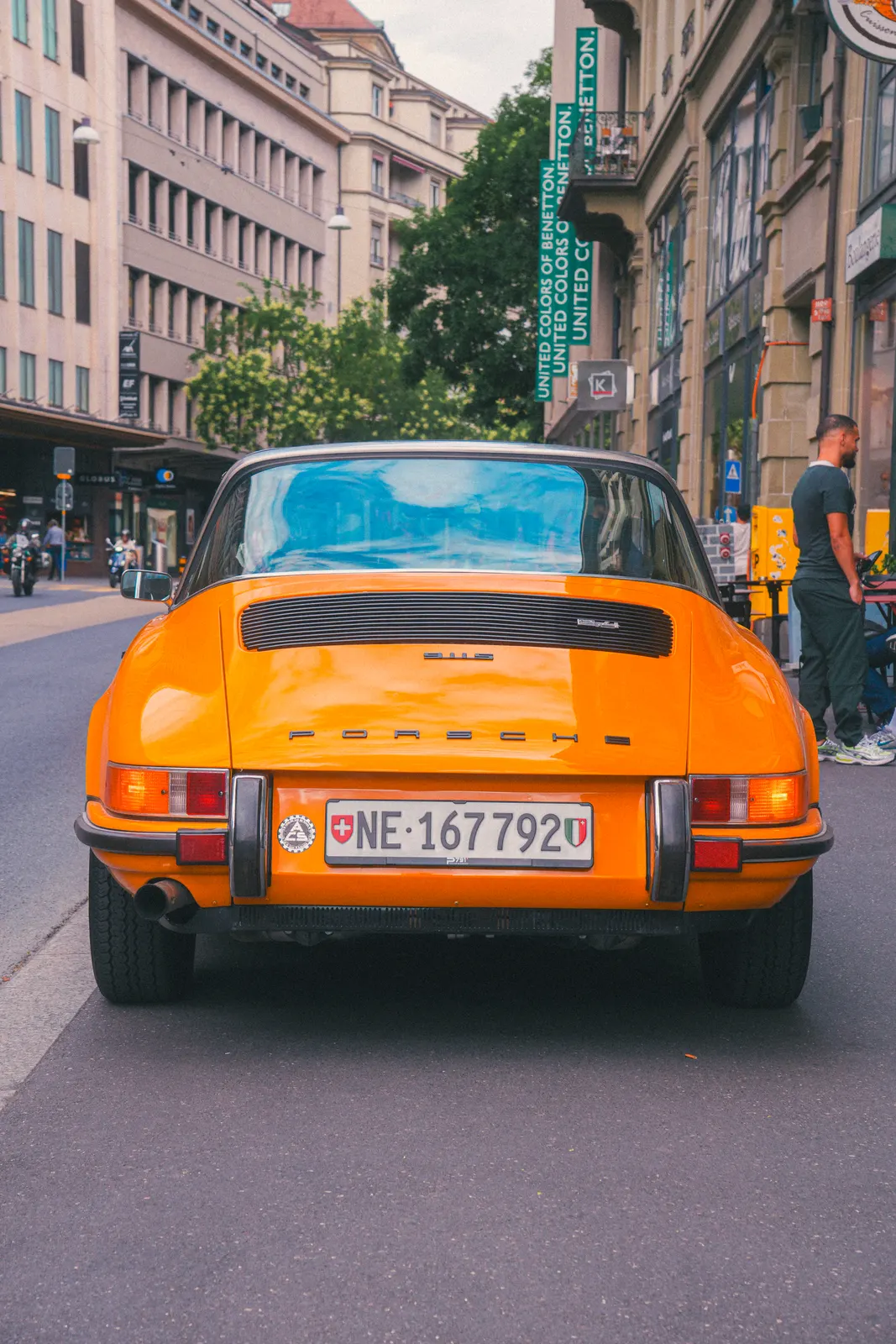 Orange vintage Porsche 911 on a European street