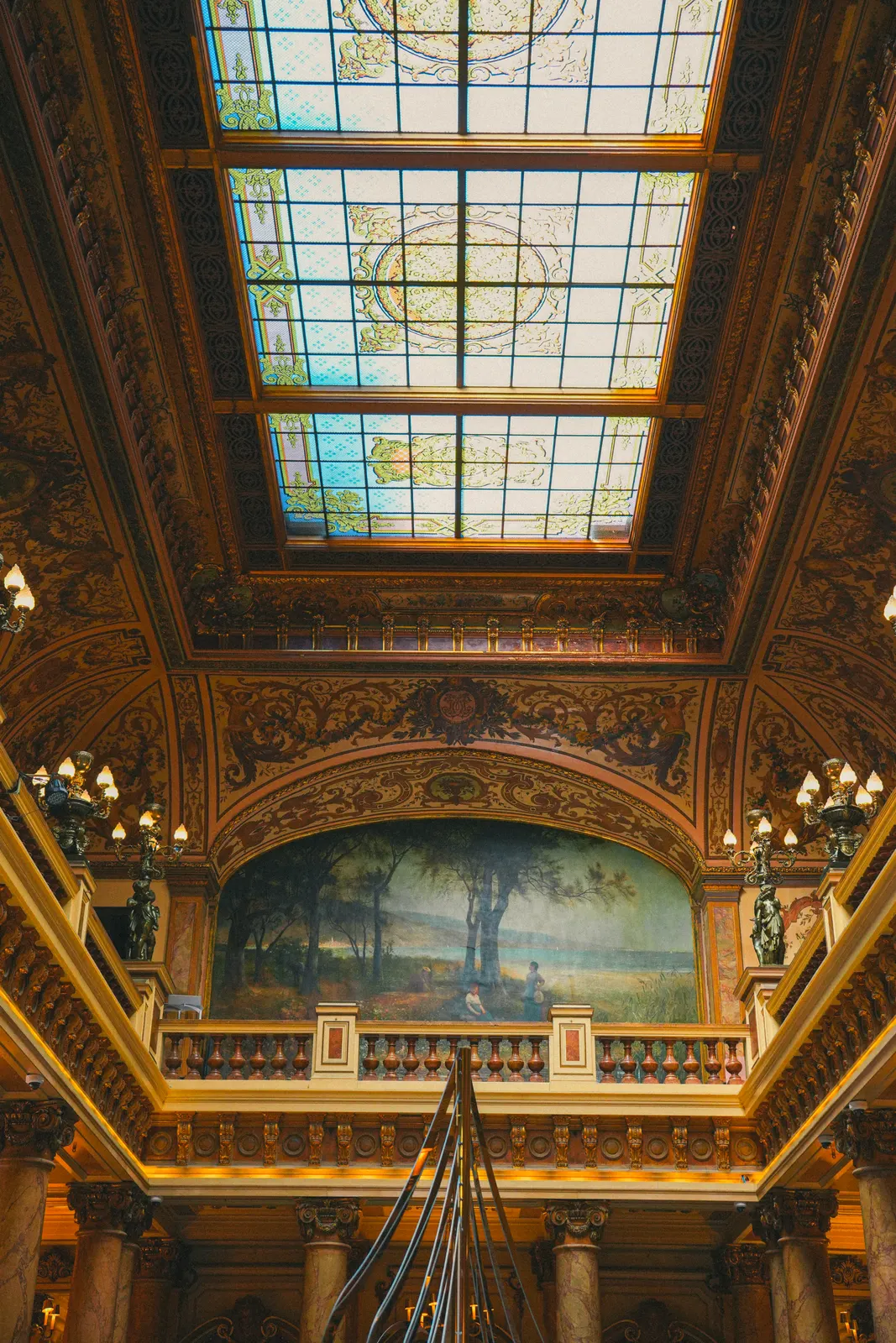 Ornate historic interior with stained-glass ceiling